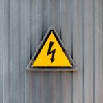 High voltage symbol on metal