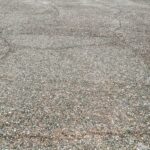 Cracked street covered with small stones