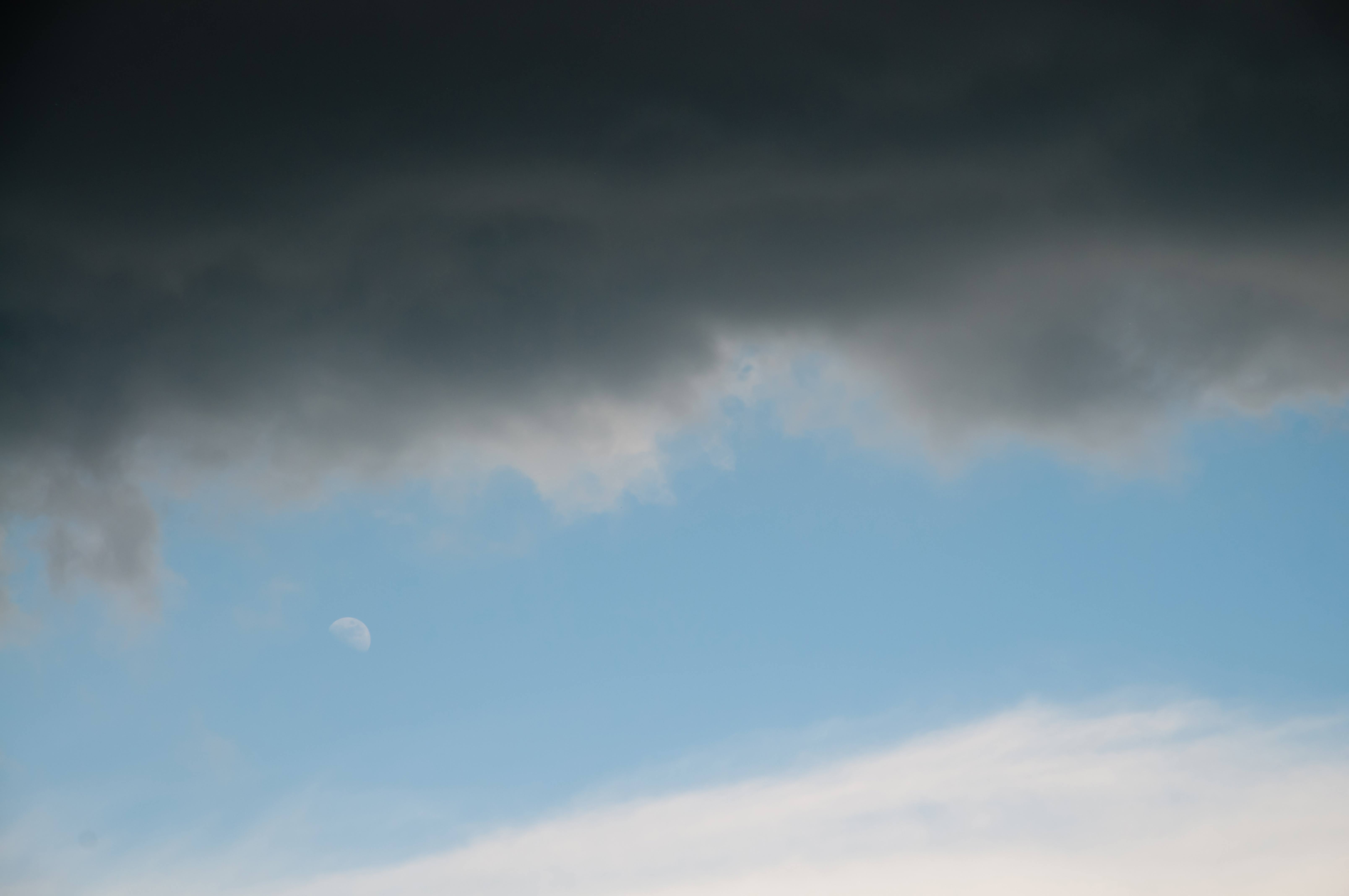Dark clouds moon and blue sky