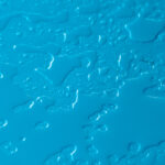Large water drops and stains on blue surface