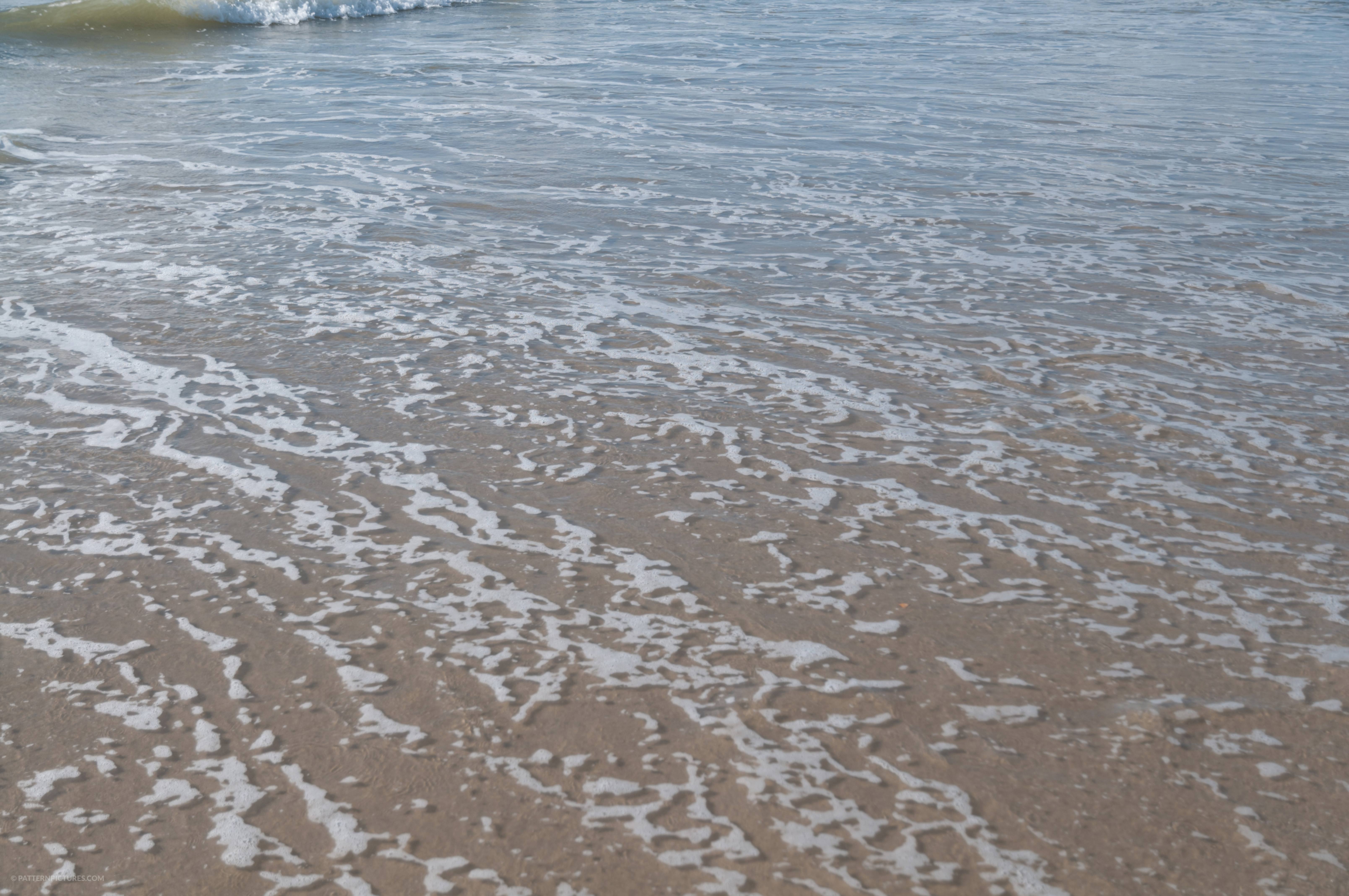 Low surface water beach shore close up