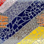 Mosaic tiles reaching hands