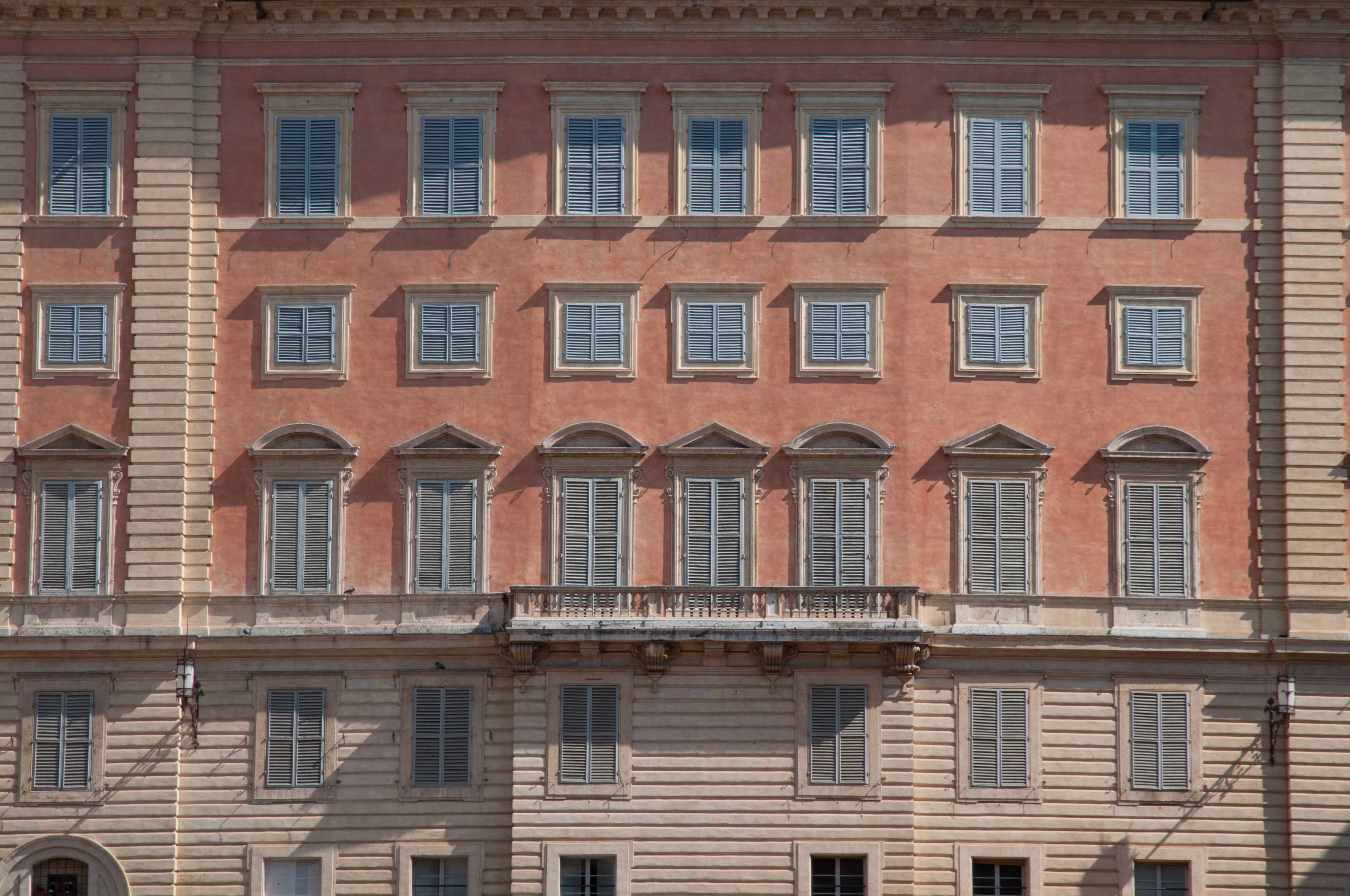 Old Italian building facade shutters closed