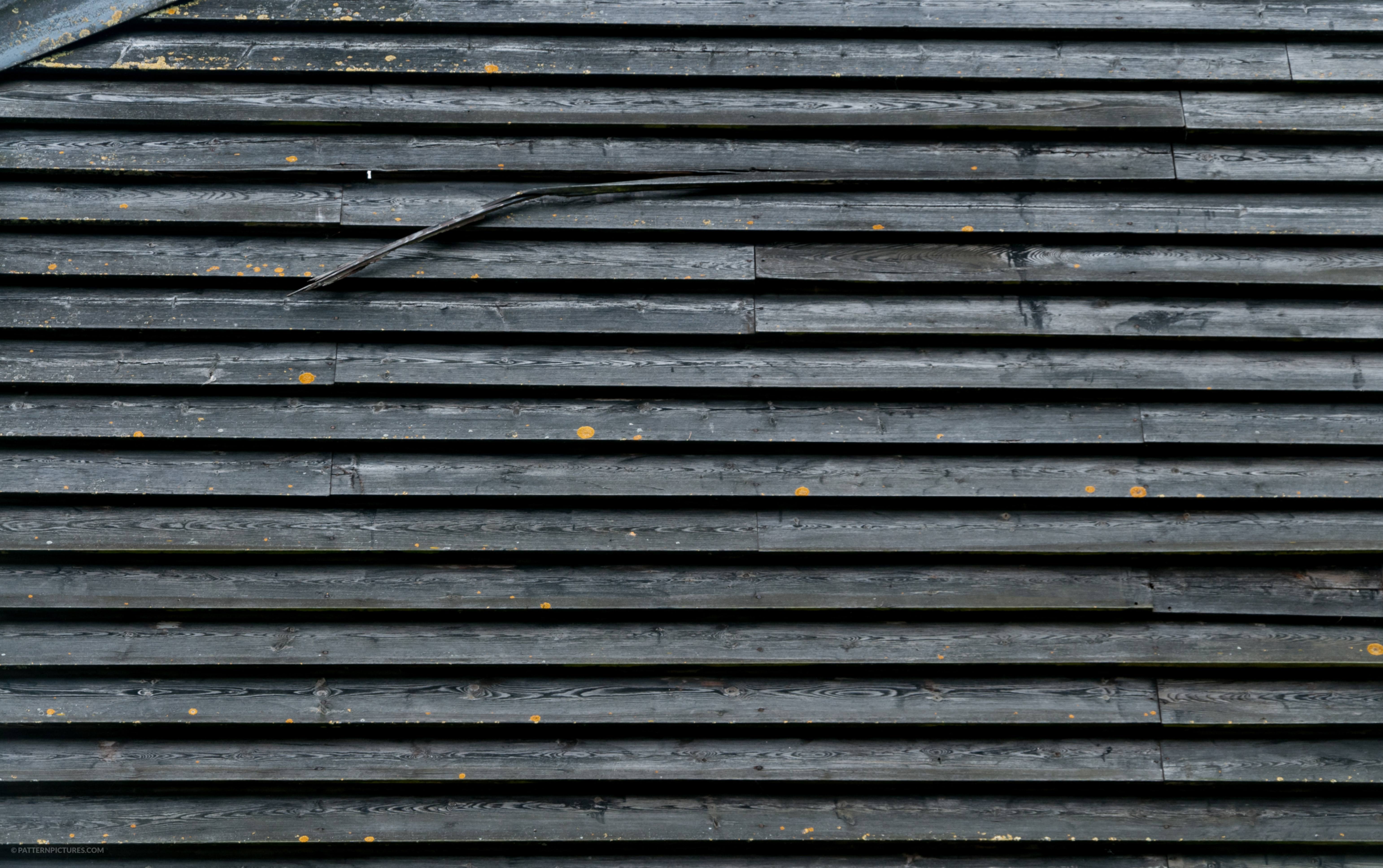 Old black wooden house wall surface