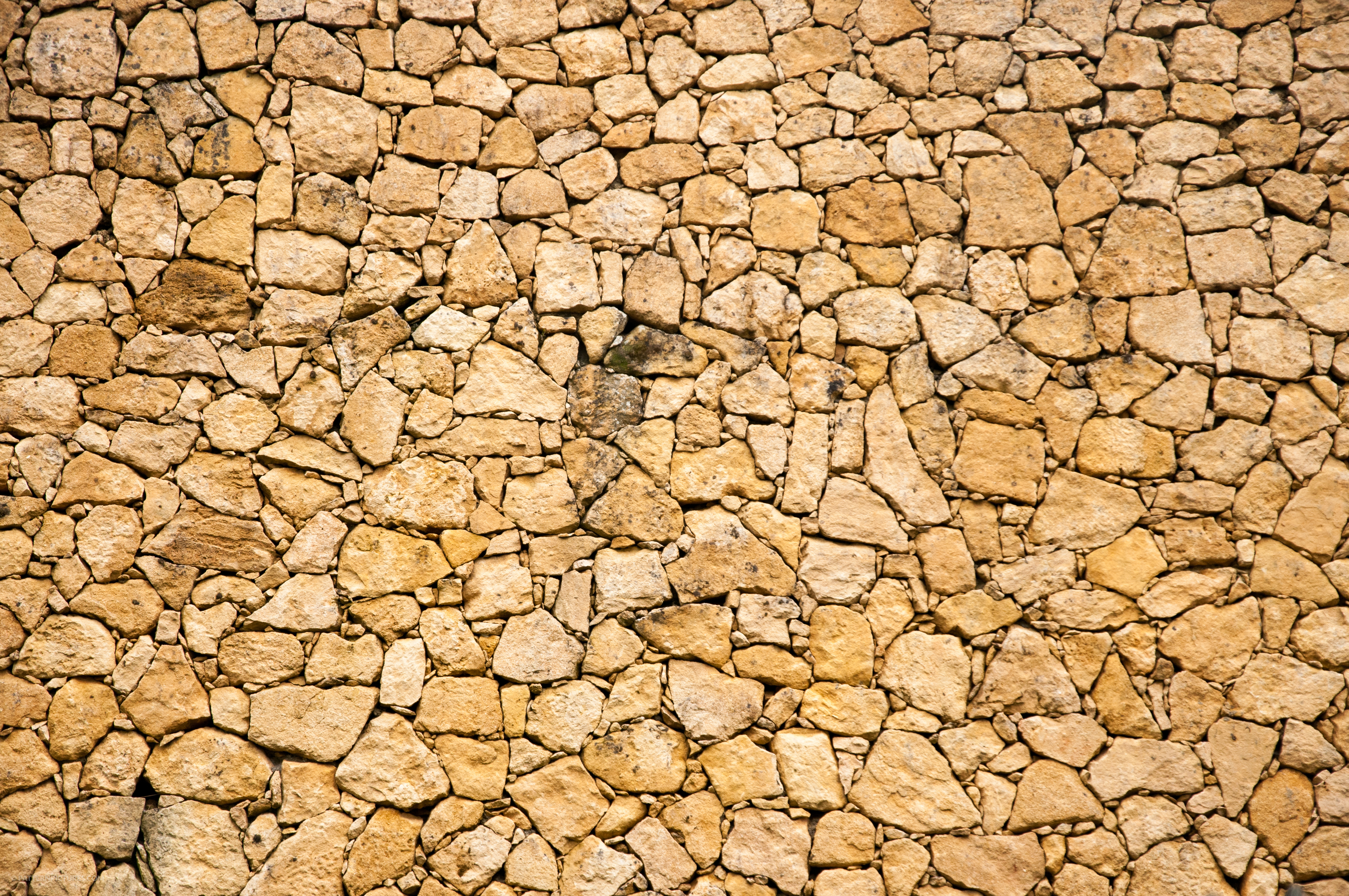 Old medieval stone rocks wall sand color
