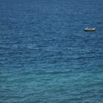 Single boat on wide ocean
