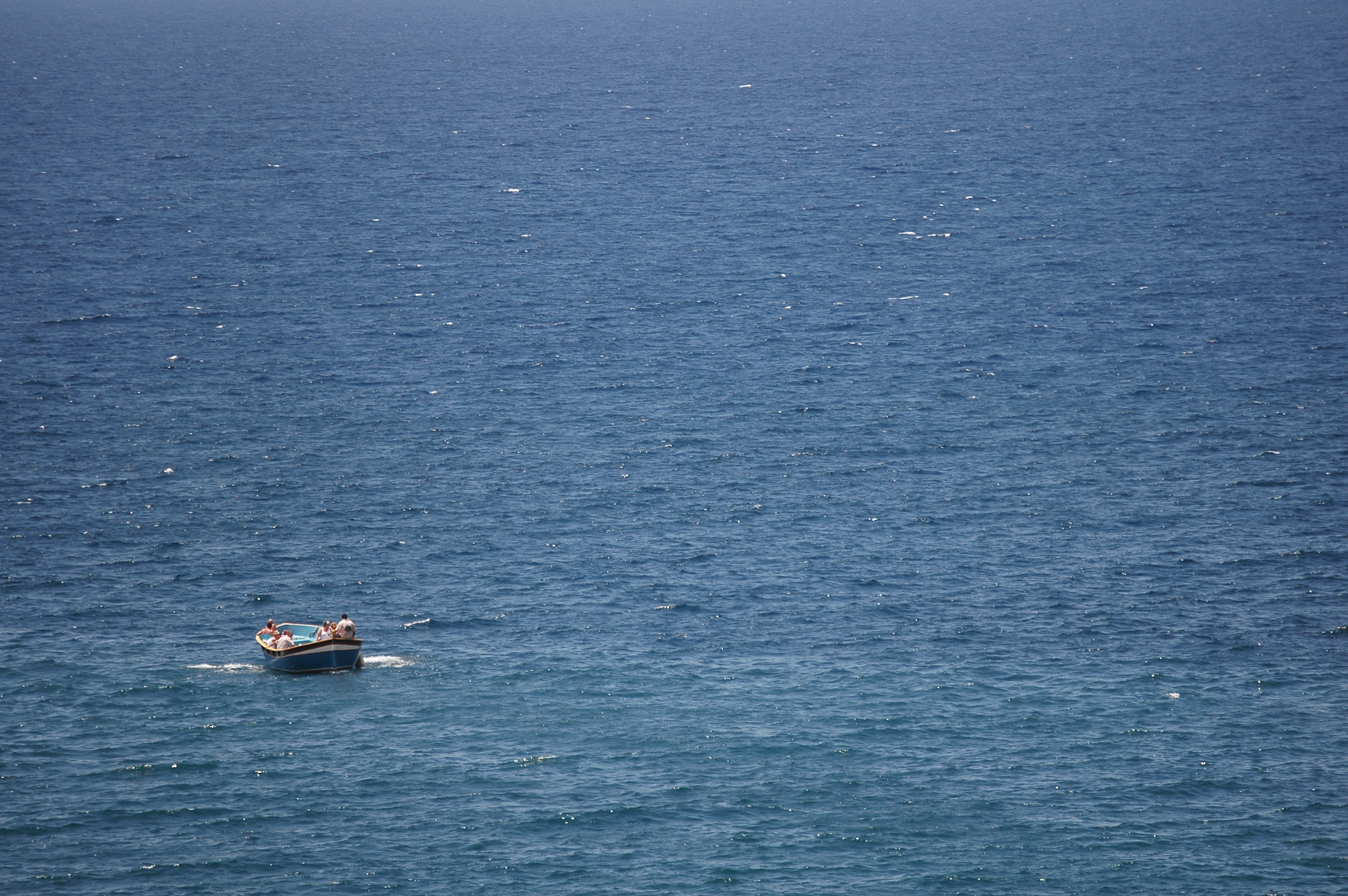 Small pleasure boat sailing at sea