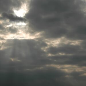 Sunbeams burst through dark clouds