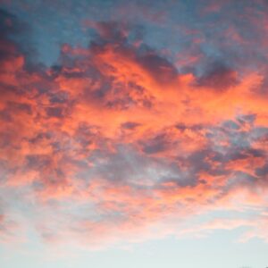Sunset reflection on orange bright lit clouds