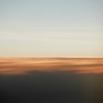 Vague sunrise projection on top of clouds