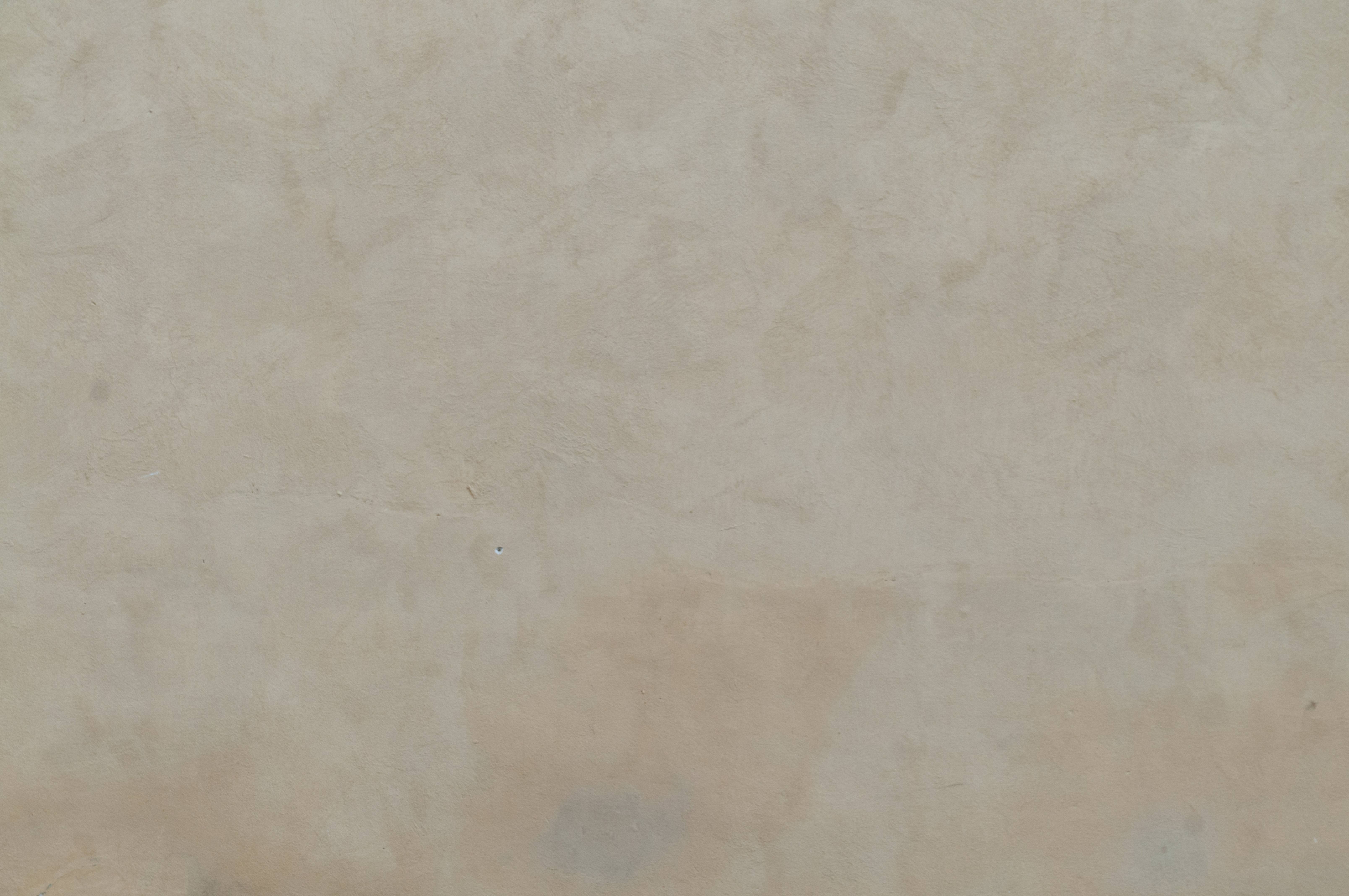 Warm white colored subtle grain plastered wall