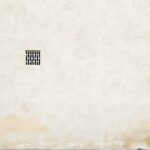 White stone wall with ventilation grate