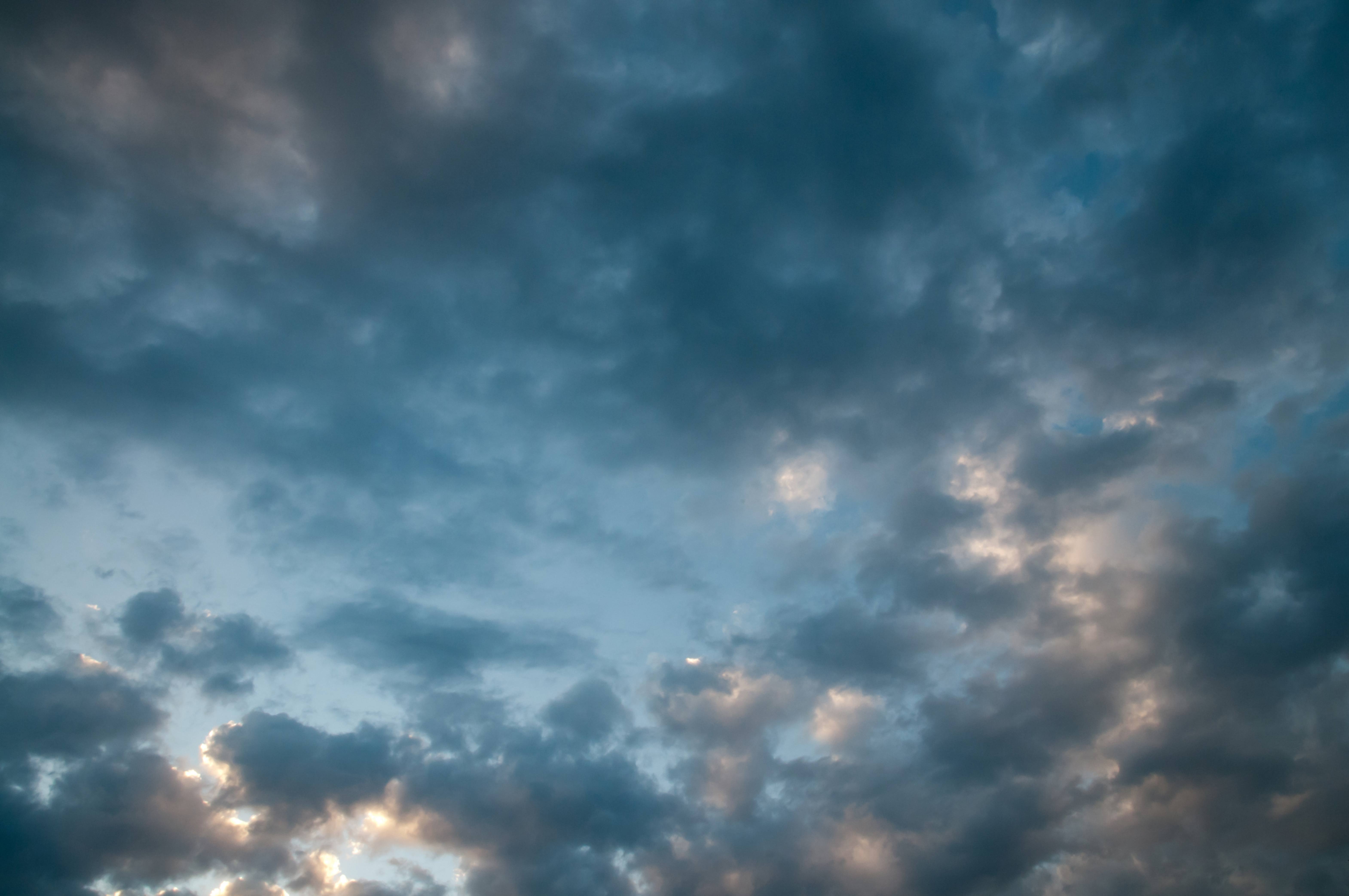 Dark small clouds in front of blue sky