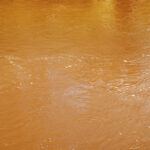 Filthy muddy river water