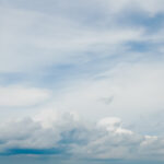 Big mid-level clouds on blue sky