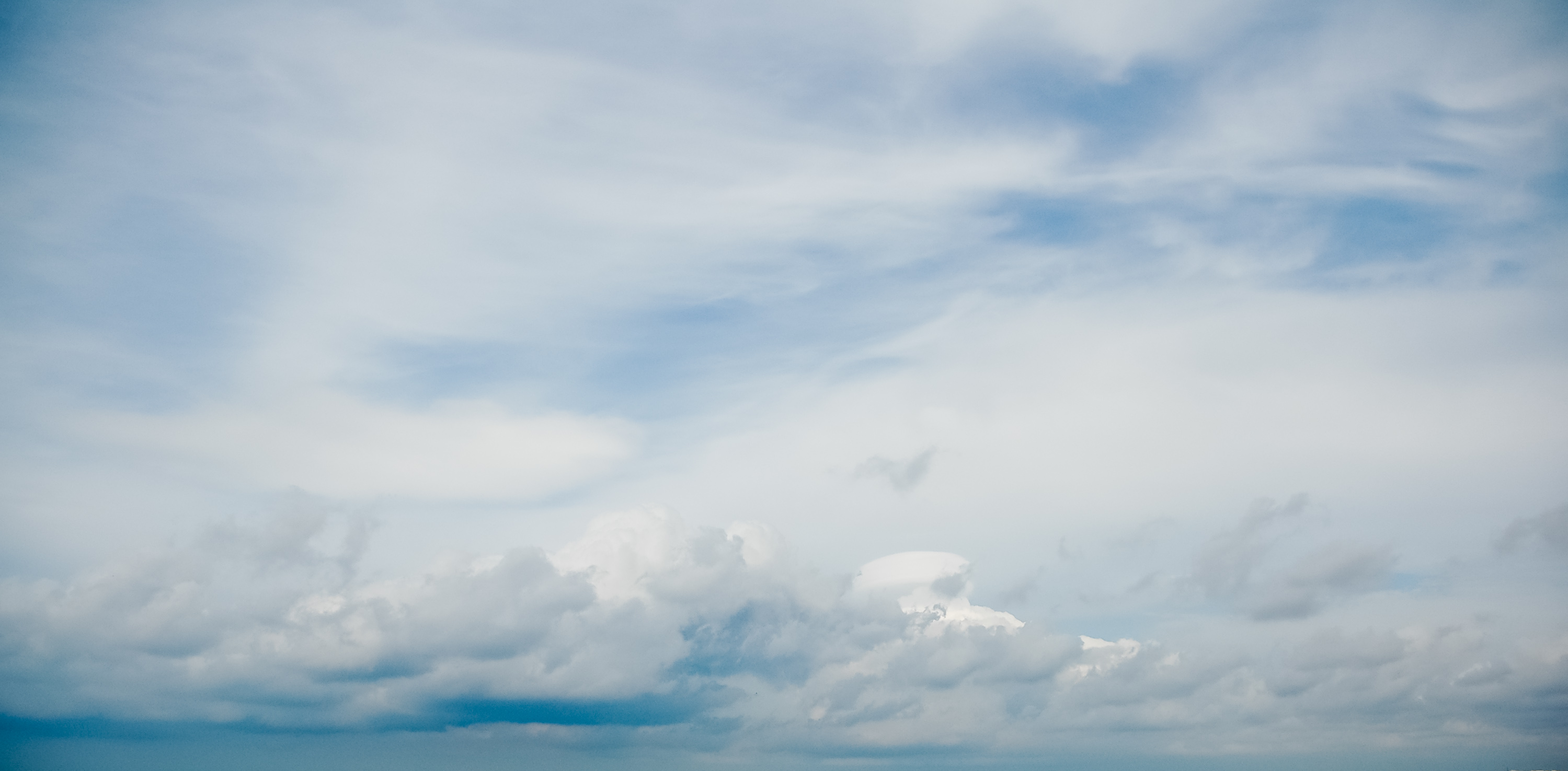 Big mid-level clouds on blue sky