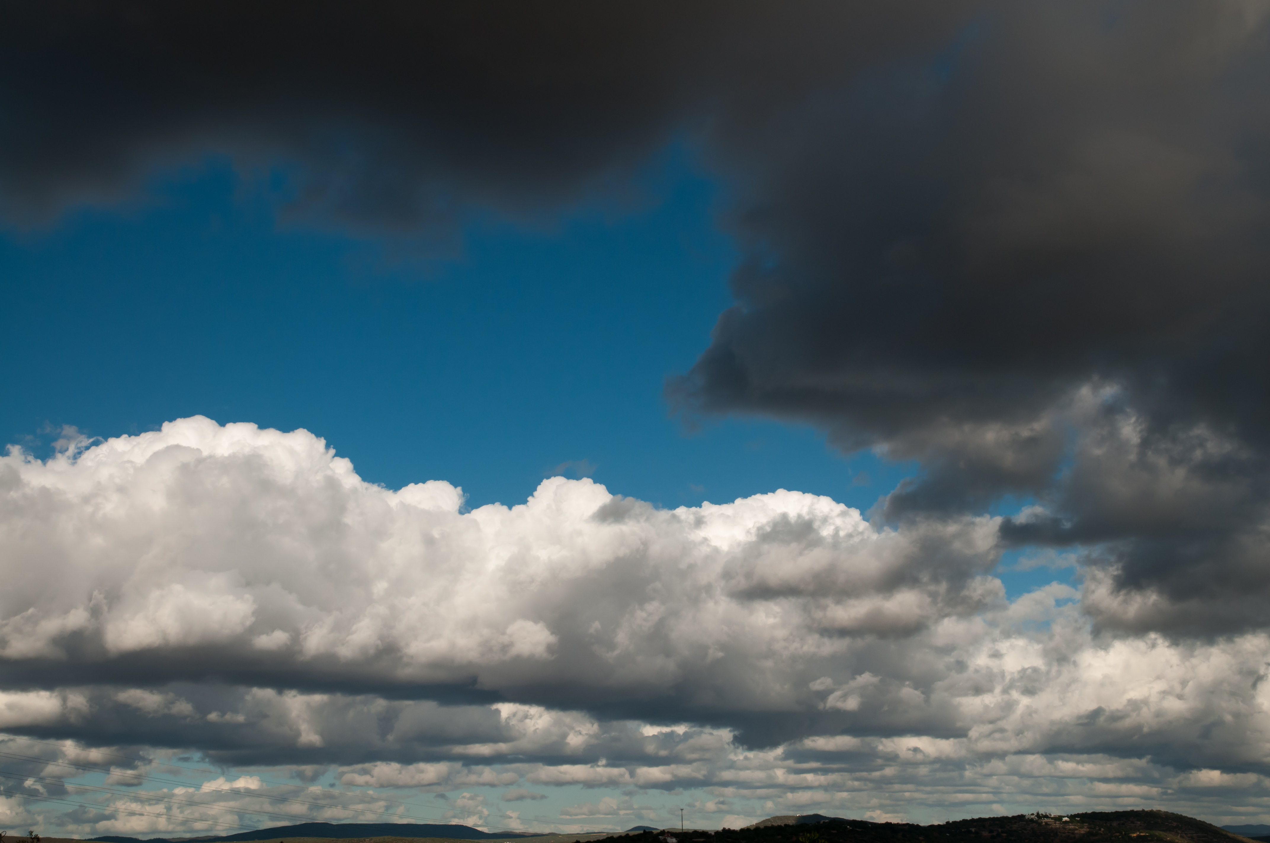 White and dark grey clouds with blue sky