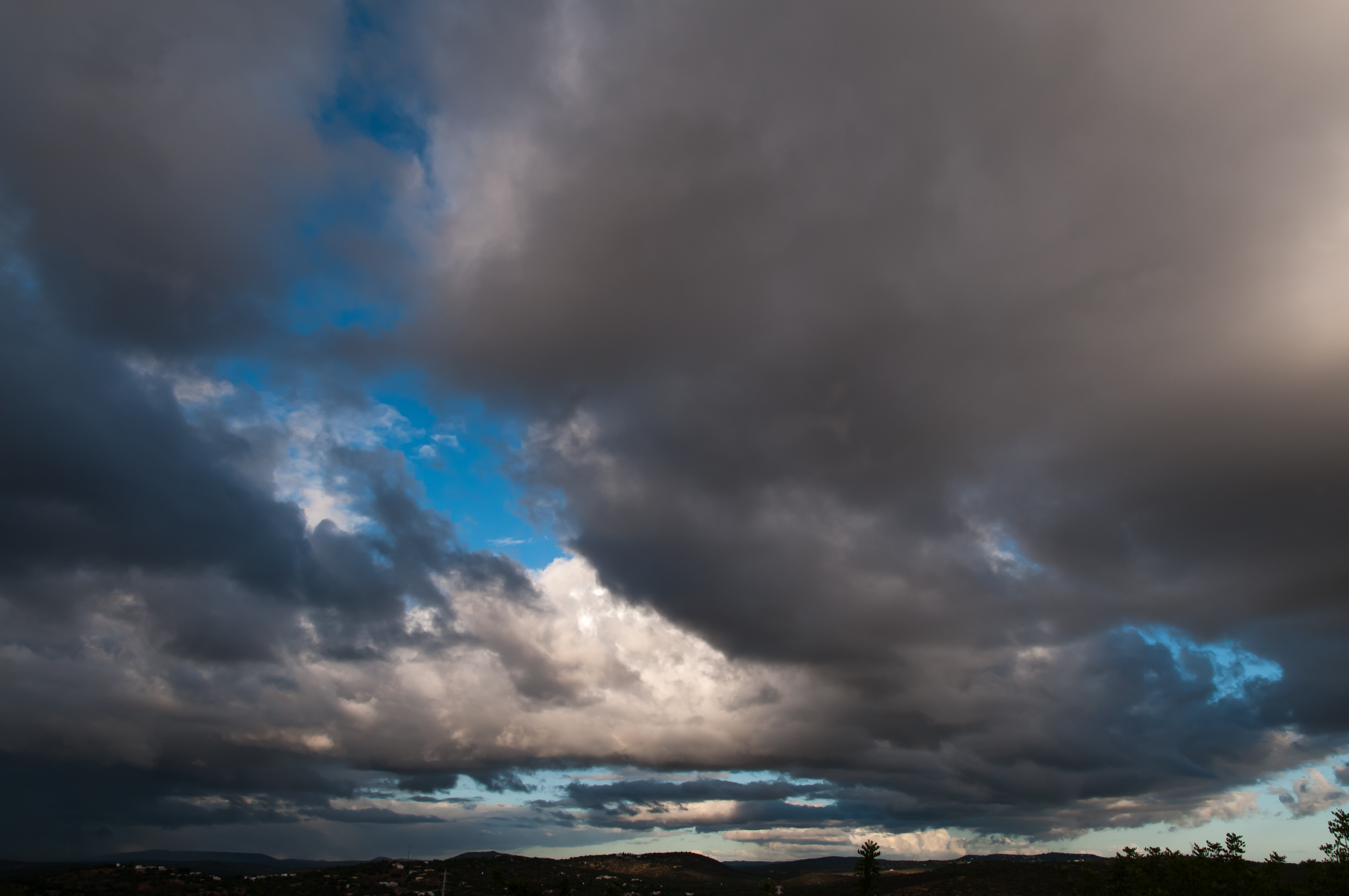 Heavy dark clouds on a blue sky