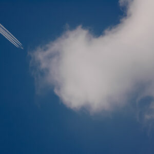 White cloud trail from jet flying high in the sky