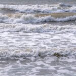 Foam waves at the beach sea background