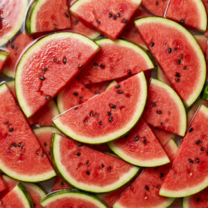 Watermelon slices, randomly piled in water